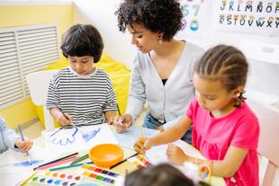 Tutor and young children painting together