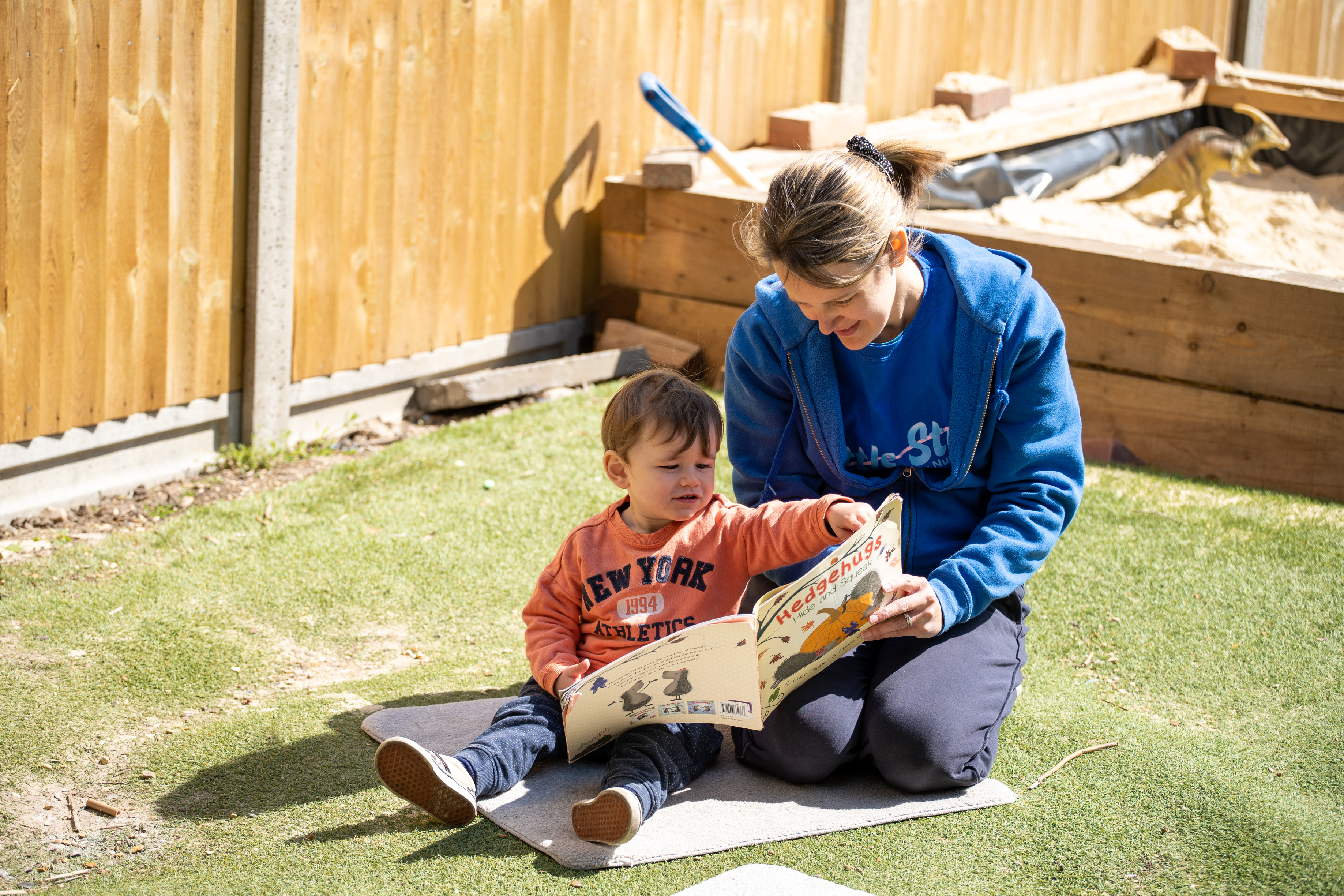 A person and a child reading a book