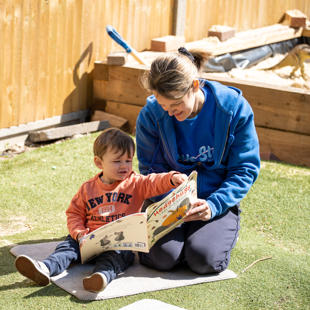 A person and a child reading a book