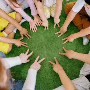 Early years and childcare - group of children sitting on carpet