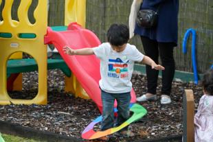 Early years and childcare - young boy playing with hoop