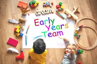 Children on the floor surrounded by toys